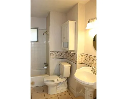 a white toilet sitting next to a bathroom sink