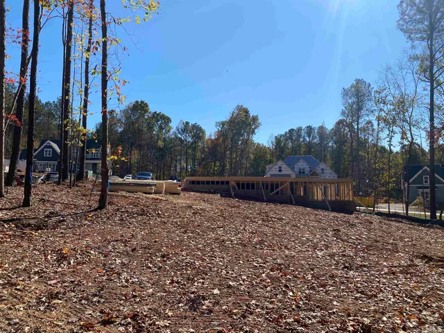 a view of a yard with wooden fence