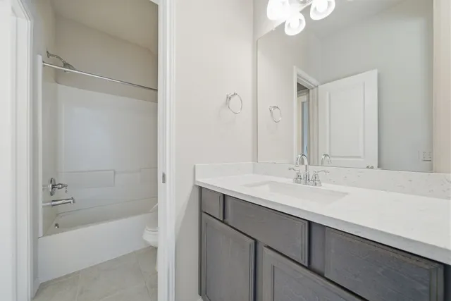 a bathroom with a tub sink and mirror