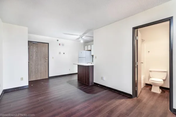 a view of a room with wooden floor and bathroom view