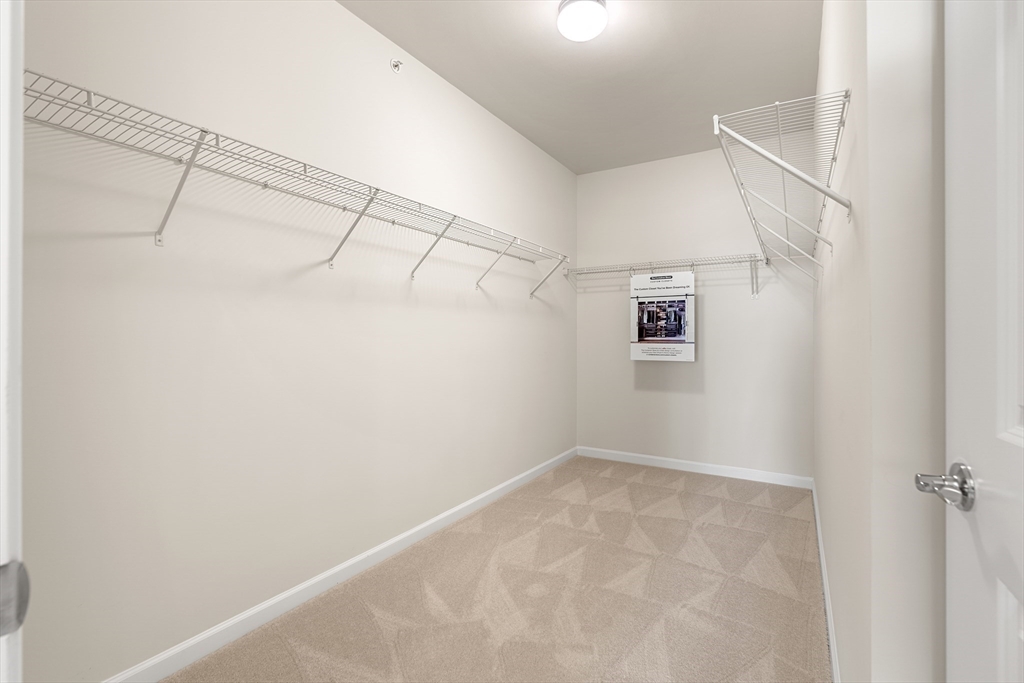 30 Coppersmith Way, Unit 408 Canton, MA 02021 - Photo 20 of 26 a view of a room with racks on the wall