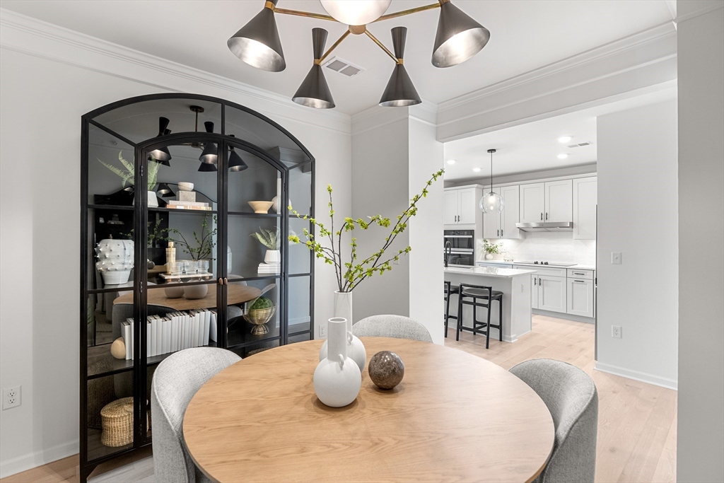30 Coppersmith Way, Unit 408 Canton, MA 02021 - Photo 10 of 26 a large white kitchen with a table and chairs