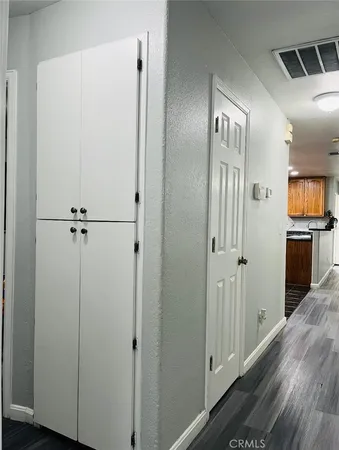a view of a hallway with wooden floor