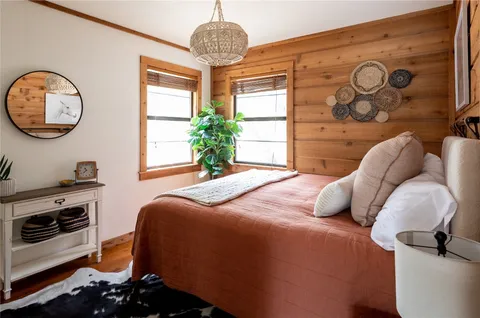 a bedroom with a bed and a chandelier
