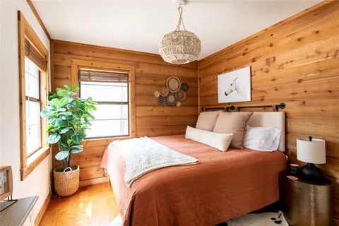 a bedroom with a bed and a potted plant