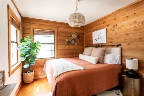 a bedroom with a bed and a potted plant