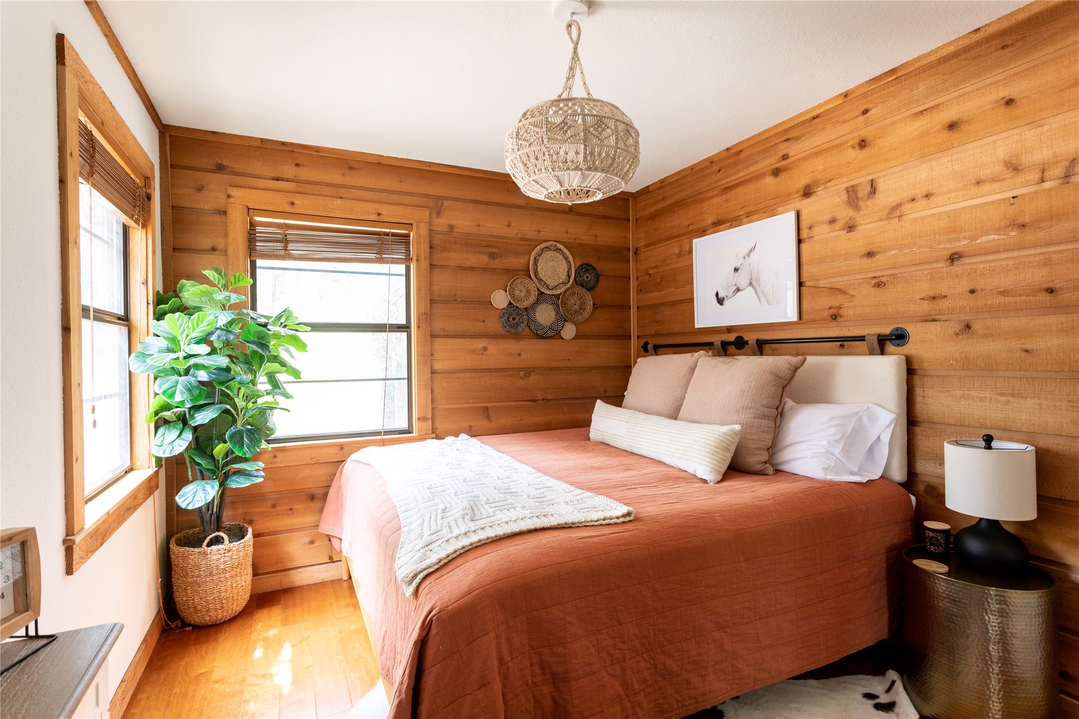 336 Coventry Road Spicewood, TX 78669 - Photo 12 of 32 Bedroom featuring wood walls and wood finished floors