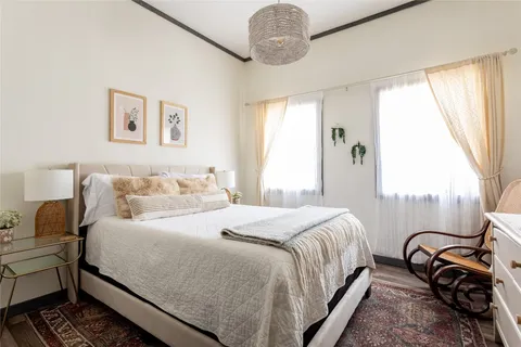 a bedroom with a bed and a chandelier