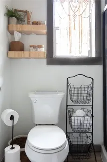 a white toilet sitting next to a bathroom sink
