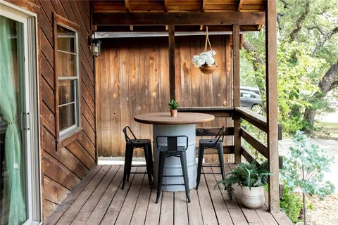 a view of balcony with wooden floor and outdoor seating