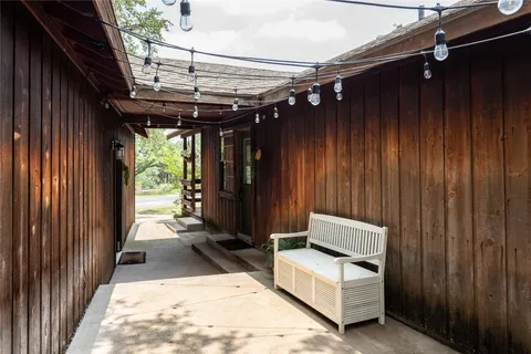 a view of a house and couches with wooden floor