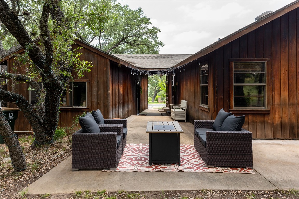 336 Coventry Road Spicewood, TX 78669 - Photo 28 of 32 a view of a house and couches with wooden floor