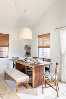 a room with furniture pool table and window
