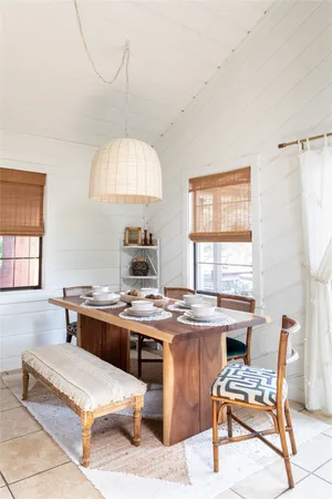 a room with furniture pool table and window