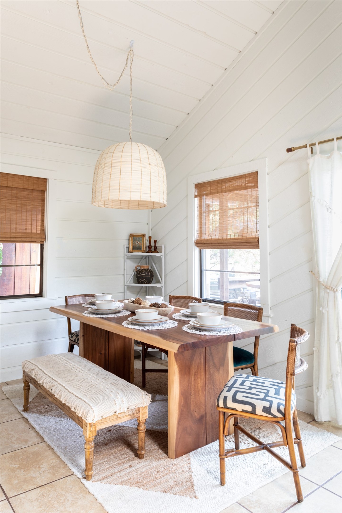 336 Coventry Road Spicewood, TX 78669 - Photo 5 of 32 Dining area with light tile patterned flooring, plenty of natural light, and wood walls