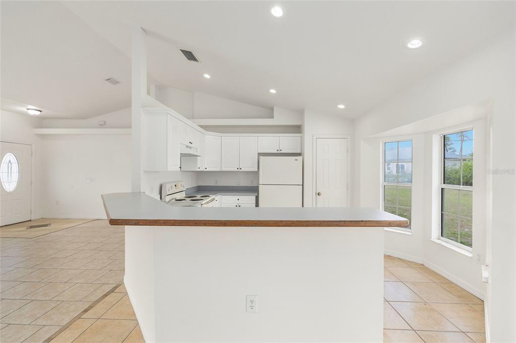 15434 Southwest 23rd Court Road Ocala, FL 34473 - Photo 18 of 41 a large white kitchen with a large window