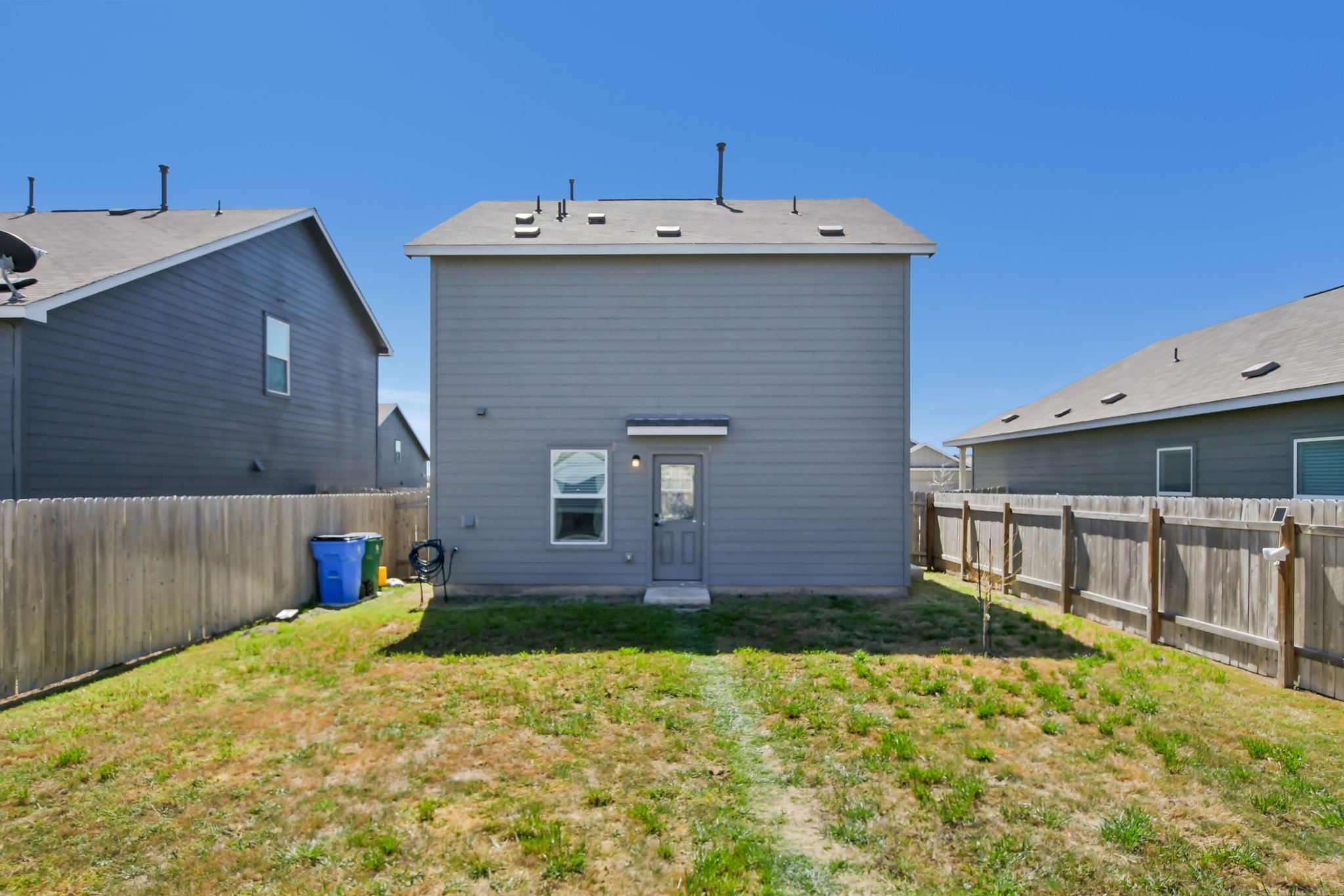 14116 Mussel Run Elgin, TX 78621 - Photo 9 of 25 Rear view of property with a fenced backyard