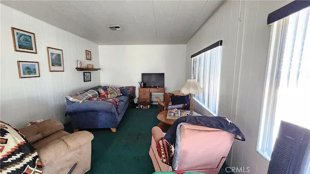 a view of a livingroom with furniture window and wooden floor
