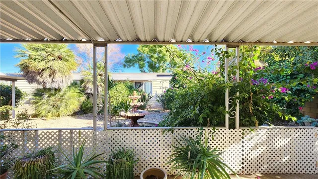 a living room with furniture a flat screen tv and kitchen view