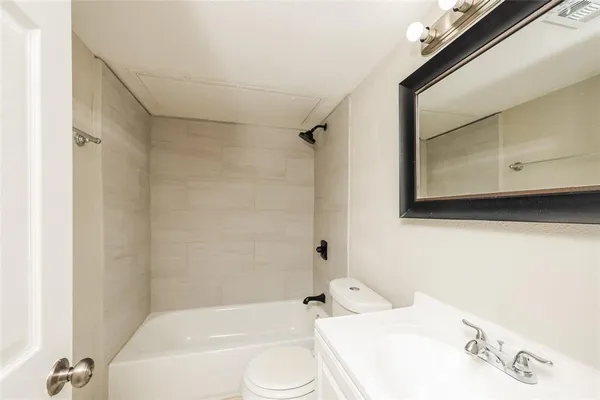 a bathroom with a sink a toilet and a bathtub