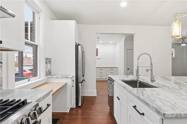 a large kitchen with a sink and a stove top oven