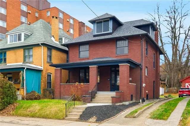 a front view of a house with garden
