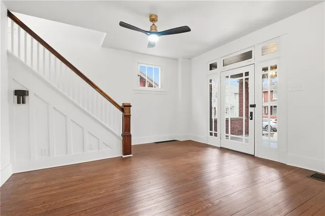 a view of an entryway with wooden floor