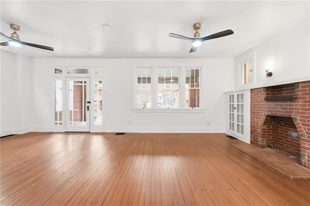 511 East 2nd Avenue Tarentum, PA 15084 - Photo 9 of 41 a view of an empty room with wooden floor and a fireplace