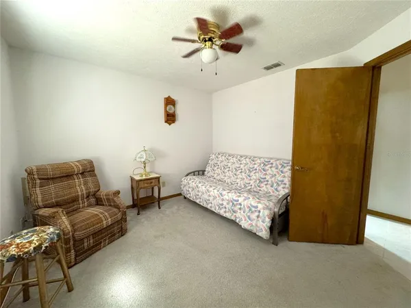 a bedroom with furniture and a ceiling fan