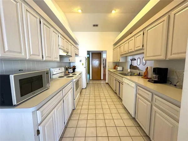 a open kitchen with stainless steel appliances granite countertop a stove and a sink