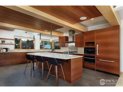 a bedroom with a bed window and a night stand