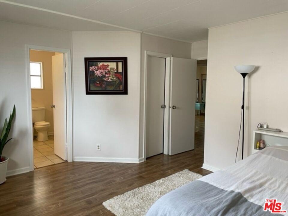 11250 Beach Boulevard, Unit 10 Stanton, CA 90680 - Photo 12 of 24 a bedroom with a bed and a view of bathroom