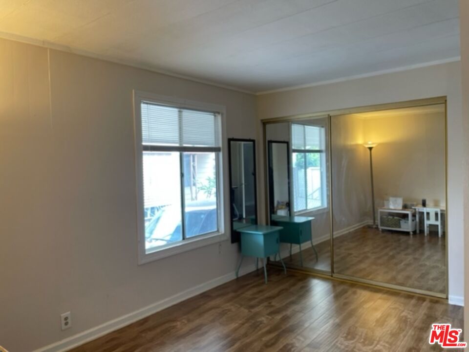 11250 Beach Boulevard, Unit 10 Stanton, CA 90680 - Photo 16 of 24 a living room with hardwood floor and a window