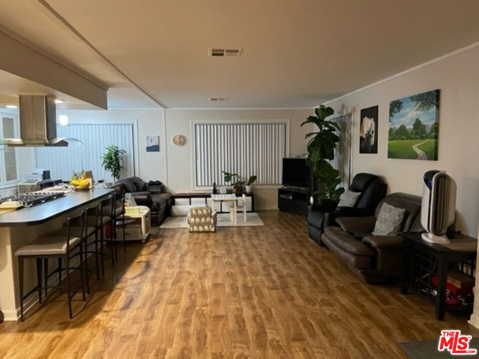 11250 Beach Boulevard, Unit 10 Stanton, CA 90680 - Photo 7 of 24 a living room with furniture and a wooden floor