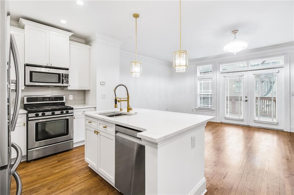13 High Top Road Sandy Springs, GA 30328 - Photo 14 of 34 a kitchen with a stove a sink and a refrigerator