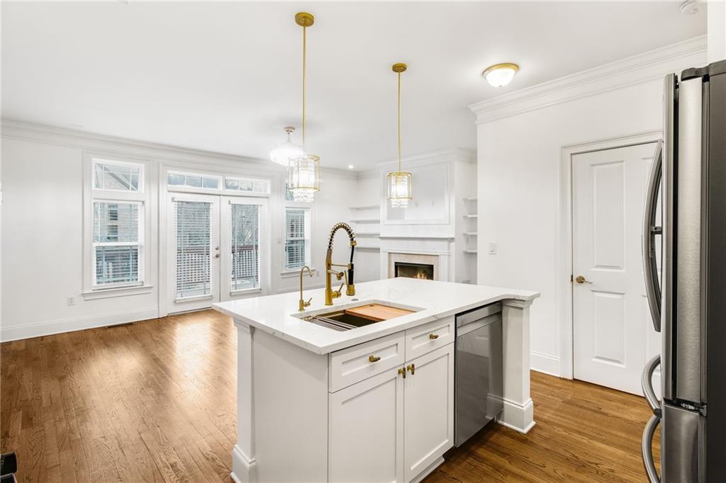 13 High Top Road Sandy Springs, GA 30328 - Photo 15 of 34 a open kitchen with a sink a stove and wooden floor