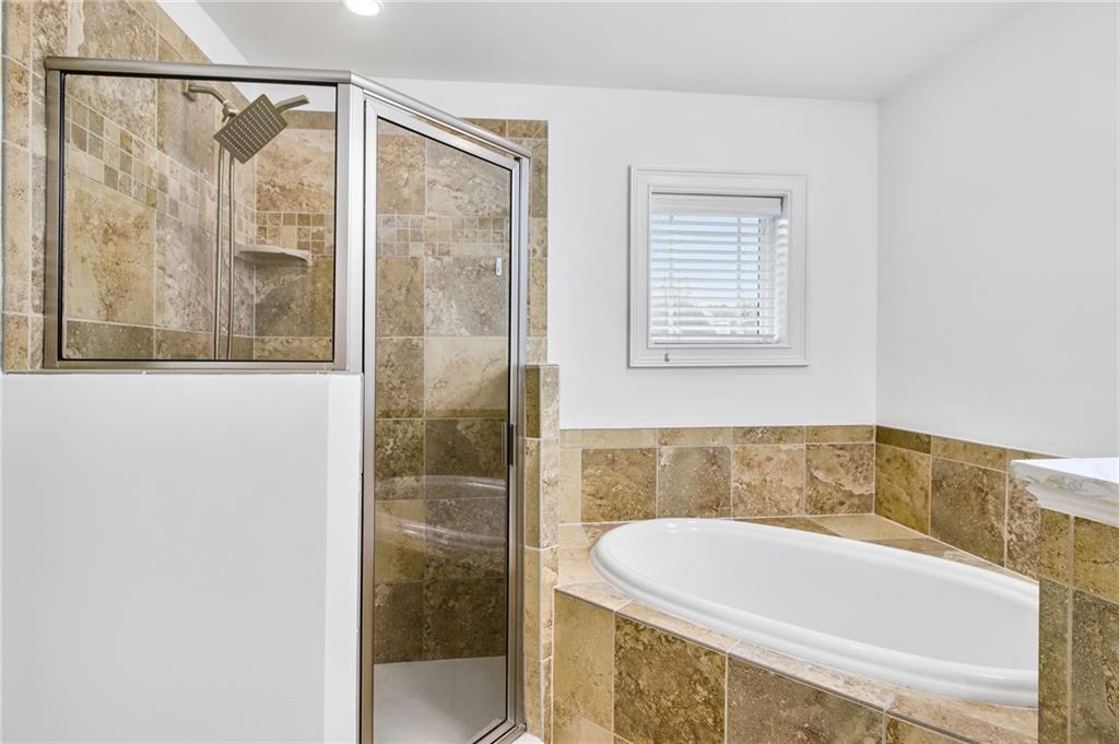 13 High Top Road Sandy Springs, GA 30328 - Photo 21 of 34 a bathroom with a bathtub and shower