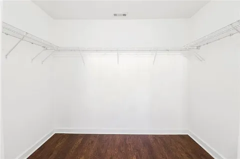 a view of a room with wooden floor