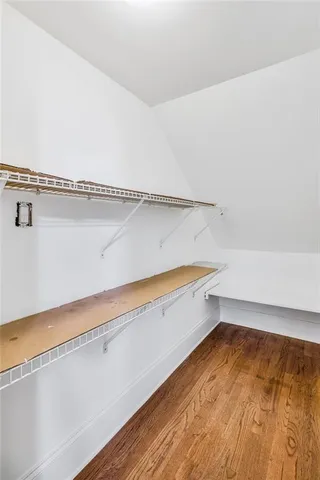 a view of a room with wooden floor