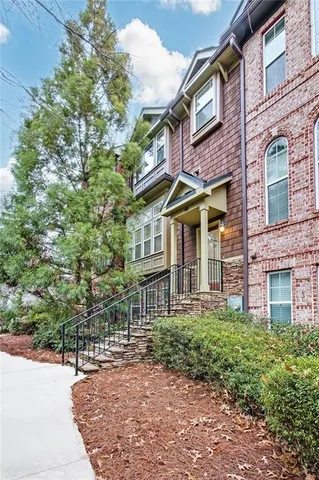 front view of a brick house with a small yard