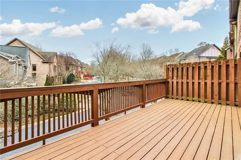 a balcony with wooden floor and city view