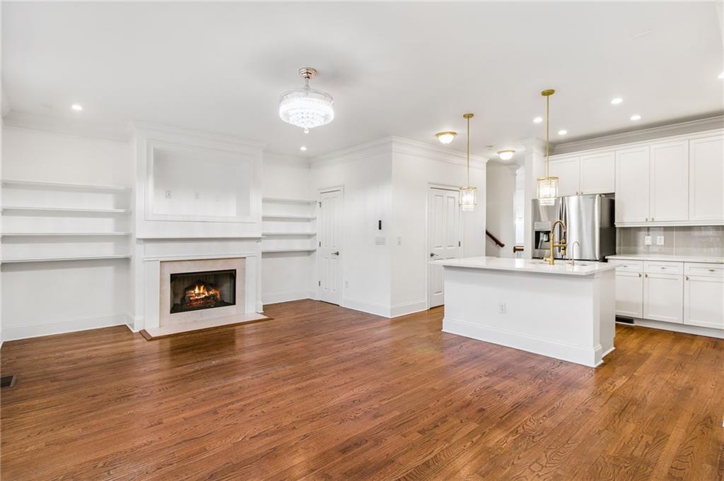 13 High Top Road Sandy Springs, GA 30328 - Photo 8 of 34 a large kitchen with cabinets wooden floor and a fireplace