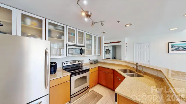 a kitchen that has a sink and a stove in it