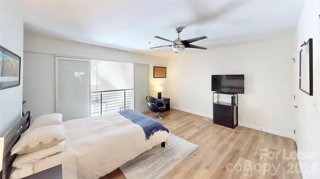 a bedroom with a bed and a tv on table