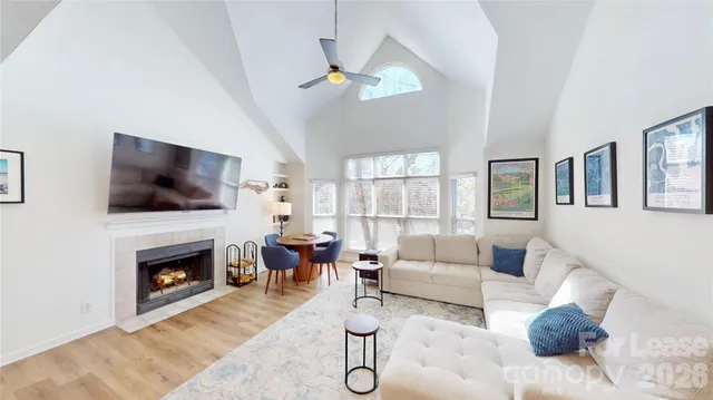 a living room with furniture a flat screen tv and a fireplace