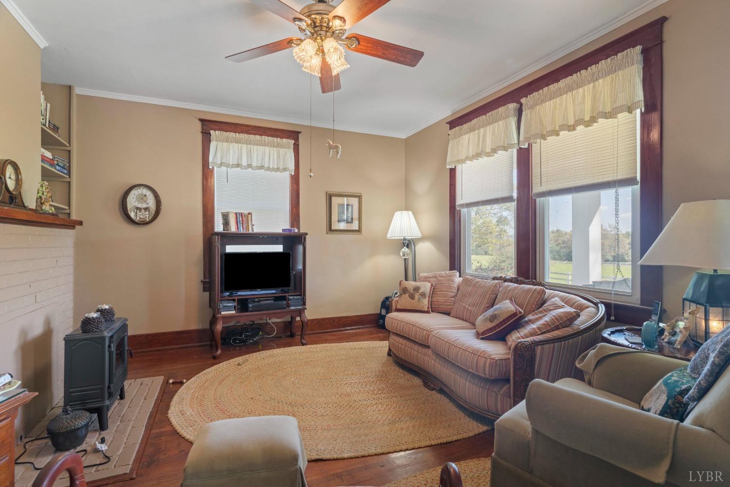 1876 Dickie Road Roseland, VA 22967 - Photo 12 of 75 a living room with furniture a large window and a flat screen tv