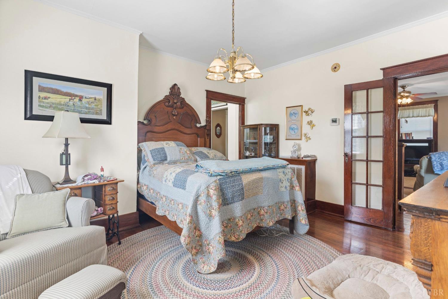 1876 Dickie Road Roseland, VA 22967 - Photo 17 of 75 a spacious bedroom with a bed a couch and a chandelier