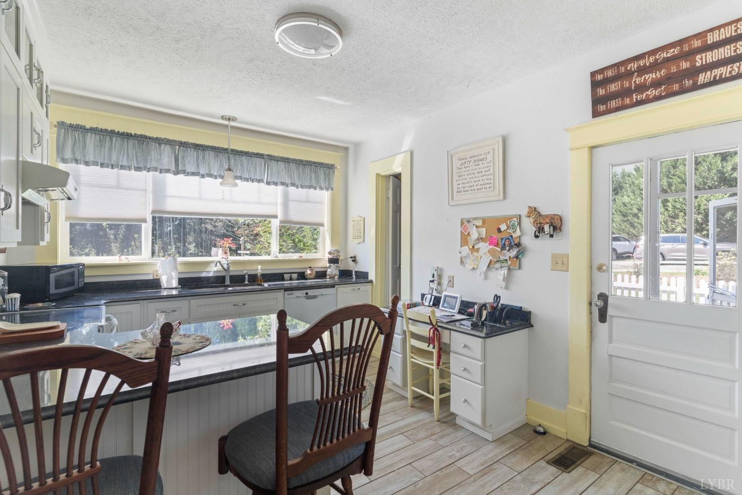 1876 Dickie Road Roseland, VA 22967 - Photo 23 of 75 a kitchen with stainless steel appliances granite countertop a stove and a dining table with wooden floor