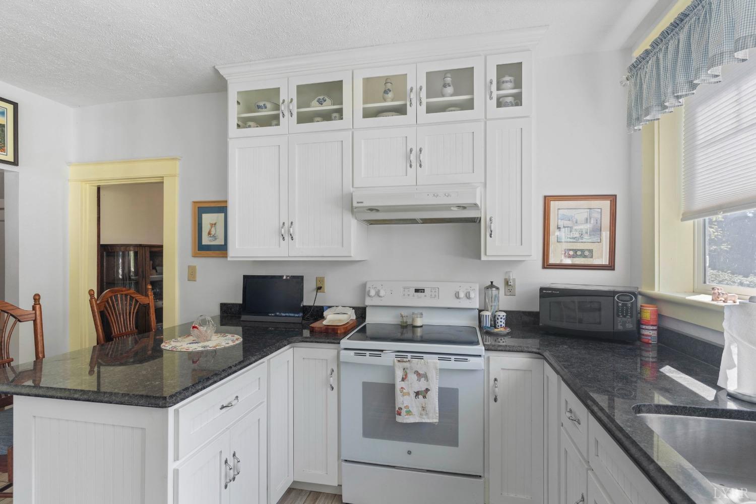 1876 Dickie Road Roseland, VA 22967 - Photo 27 of 75 a kitchen with cabinets appliances a sink and a counter top space