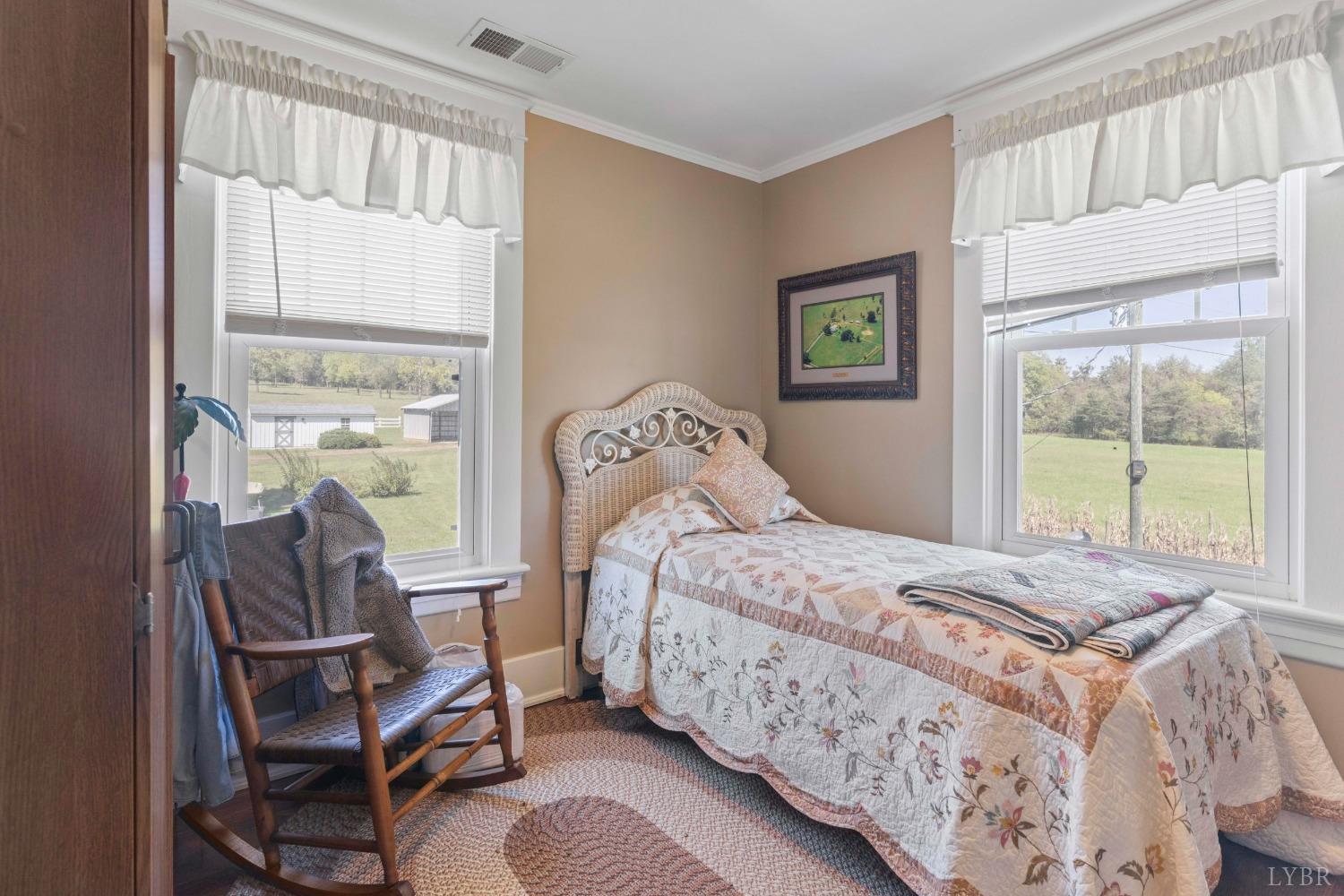1876 Dickie Road Roseland, VA 22967 - Photo 35 of 75 a bedroom with a bed and large windows